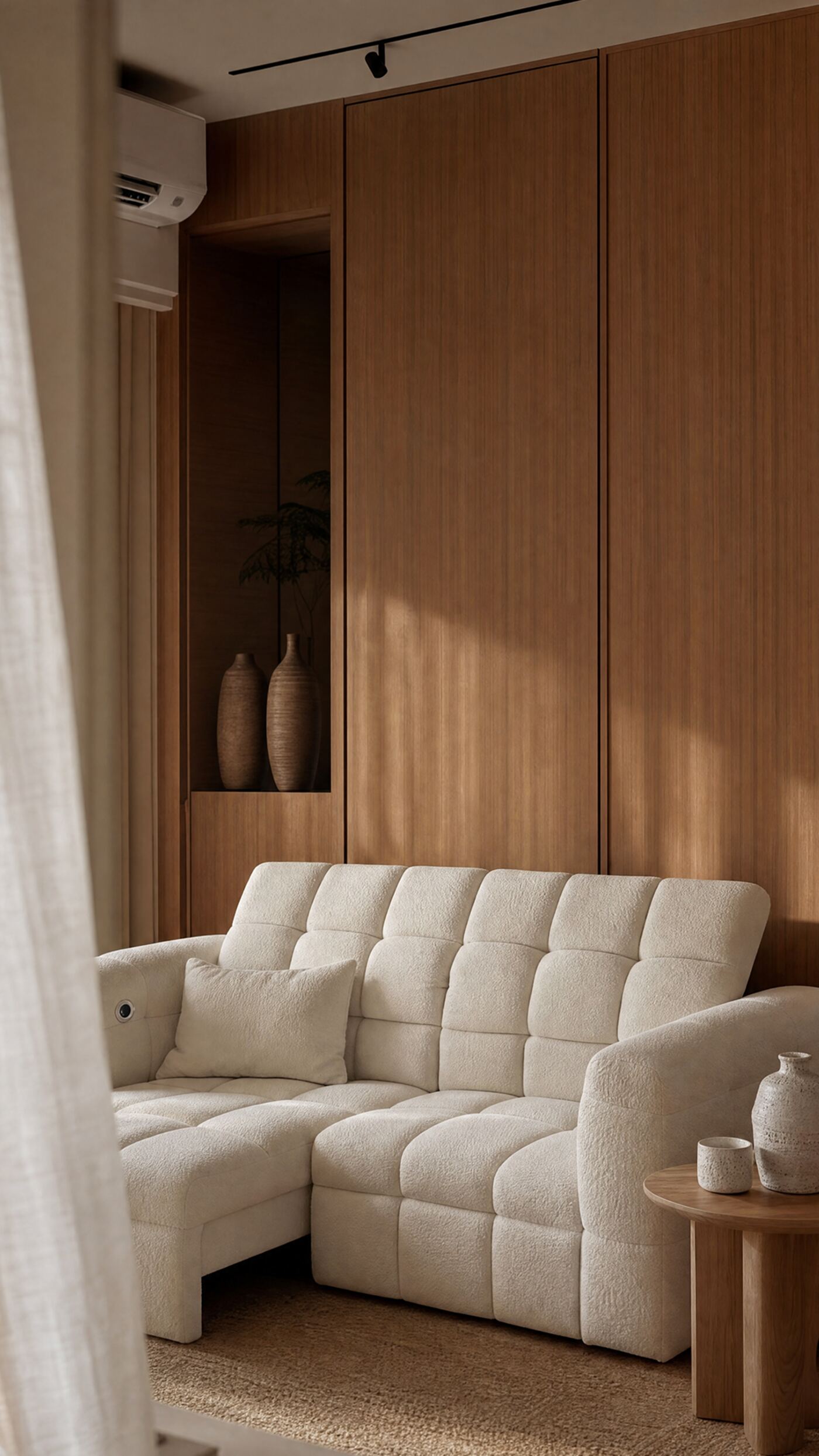 A cream boucl&eacute; extendable sofa, with its electric extend control visible on the armrest.