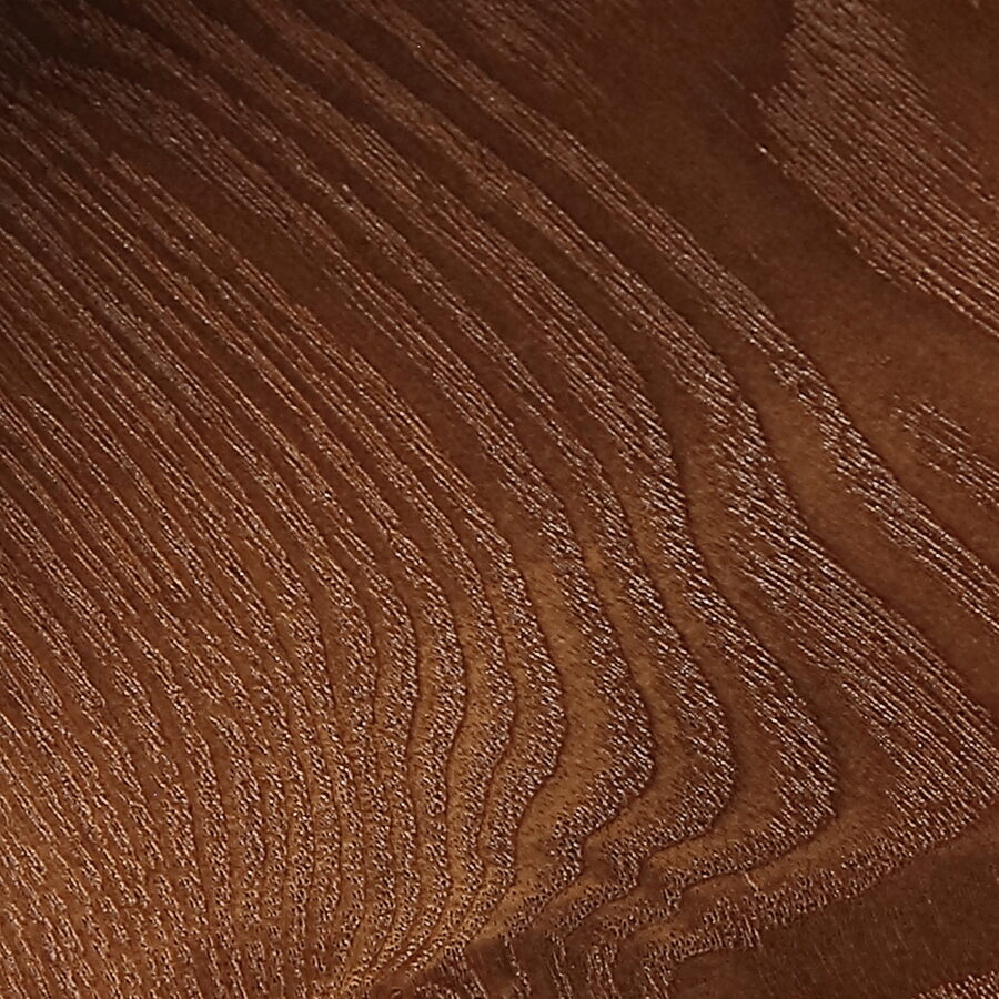 Solid walnut in close-up, its dark grain figure running through the board.